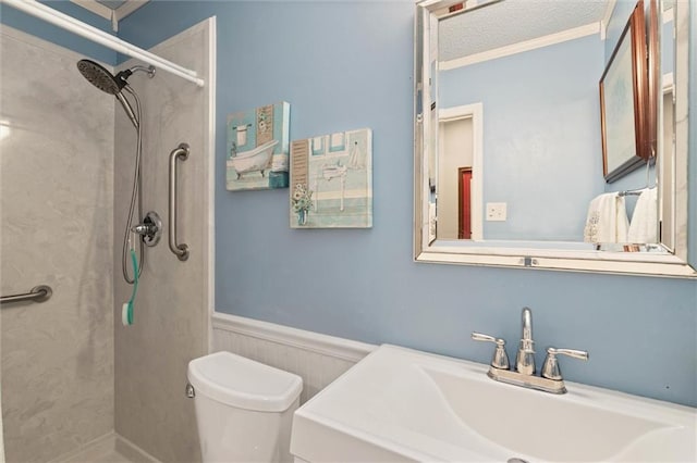 5719 Laurel Dr, Satsuma, AL 36572 - full bath with a sink, a shower, wainscoting, toilet, and crown molding