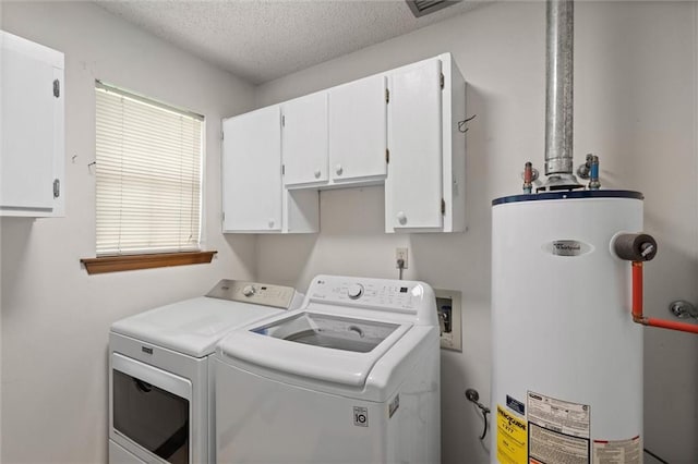 5719 Laurel Dr, Satsuma, AL 36572 - washroom featuring water heater, cabinet space, washing machine and clothes dryer, and a textured ceiling