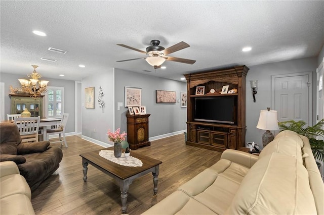 5719 Laurel Dr, Satsuma, AL 36572 - living room featuring a chandelier, wood finished floors, a textured ceiling, a ceiling fan, and baseboards
