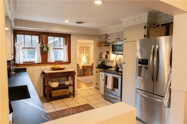 kitchen featuring light tile patterned flooring, sink, white cabinetry, wooden ceiling, and stainless steel appliances