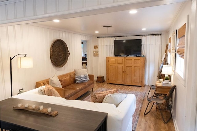 living room with wood-type flooring and crown molding