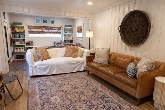 living room featuring crown molding and dark wood-type flooring