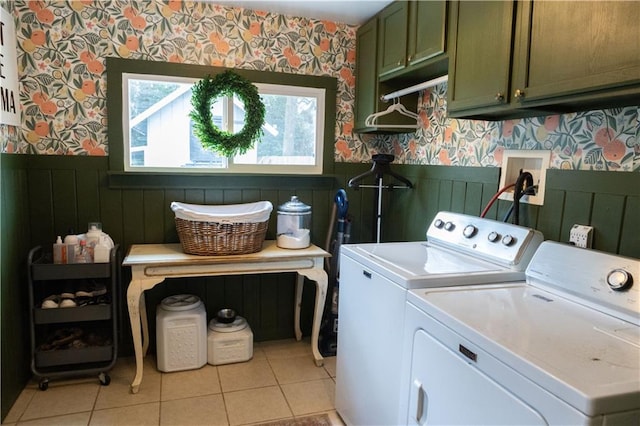 washroom with cabinets, washer and dryer, and light tile patterned floors