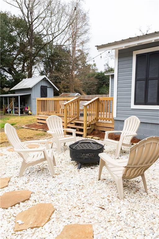 view of patio / terrace featuring a storage unit and a deck