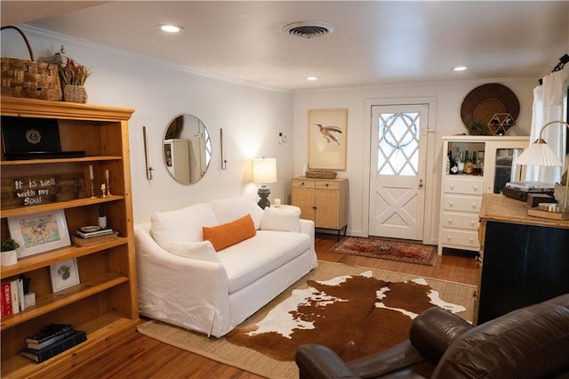 living room featuring crown molding and hardwood / wood-style flooring