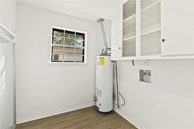 clothes washing area with water heater, hookup for a washing machine, and dark wood-type flooring