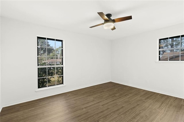 empty room with ceiling fan and dark hardwood / wood-style floors