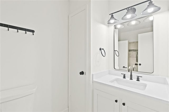 bathroom featuring toilet and vanity