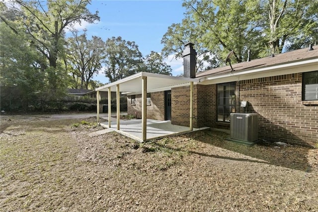 view of yard featuring central AC and a patio area