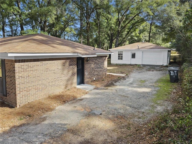 view of property exterior featuring an outbuilding and a garage