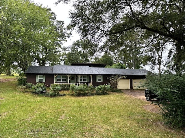 ranch-style home with a front lawn and a garage