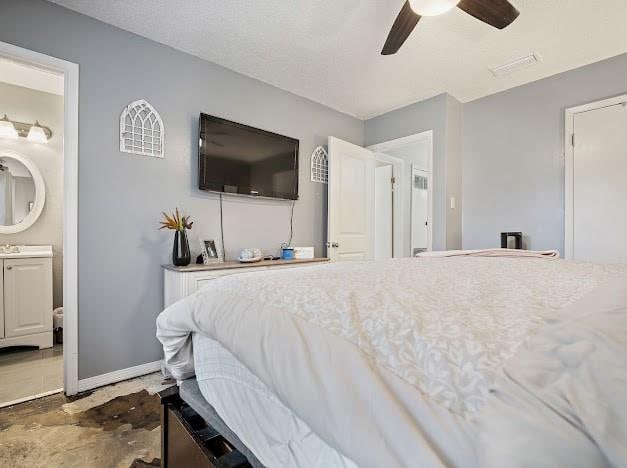 bedroom featuring ceiling fan and connected bathroom