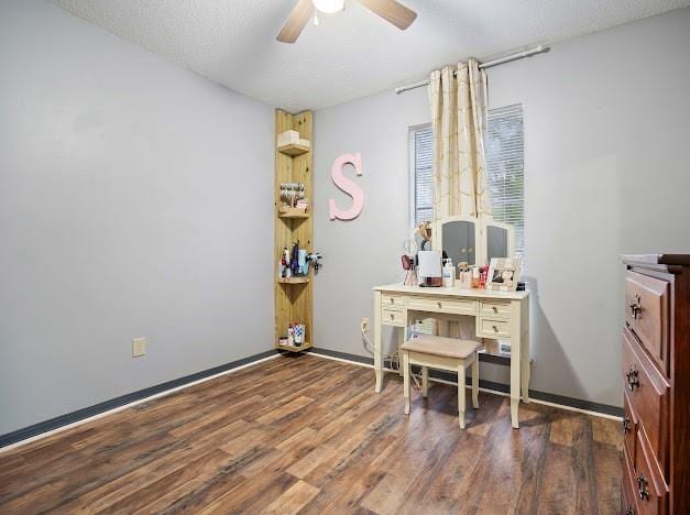 office area featuring dark wood-type flooring, a textured ceiling, and ceiling fan