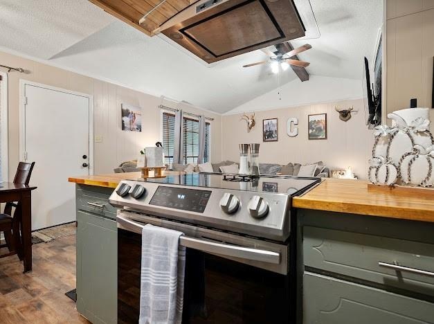 kitchen with butcher block countertops, stainless steel electric range, wood-type flooring, vaulted ceiling, and ceiling fan