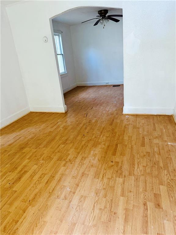 empty room featuring ceiling fan and light hardwood / wood-style flooring