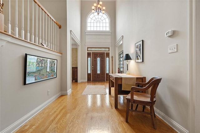 3219 Wynnfield Dr E, Mobile, AL 36695 - entryway featuring a towering ceiling, wood finished floors, and a chandelier