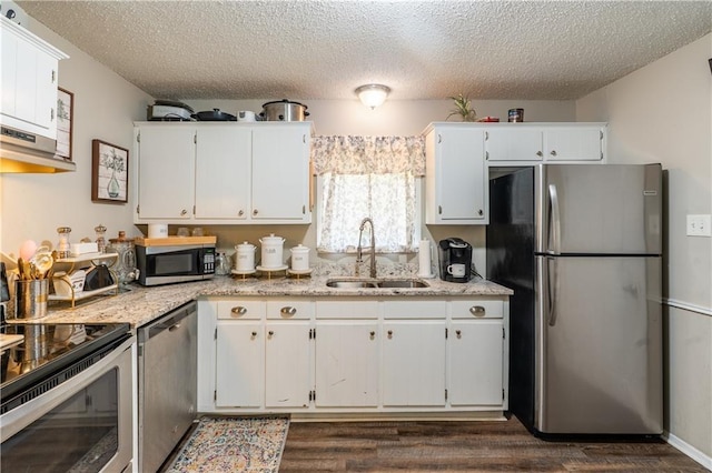 6250 Vivian Broadus Rd, Eight Mile, AL 36613 - kitchen with stainless steel appliances, dark wood-style flooring, a textured ceiling, and white cabinetry