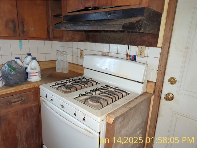 kitchen featuring tasteful backsplash and white gas range