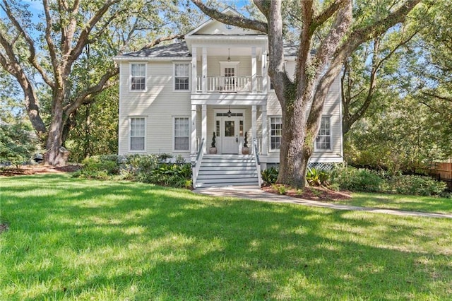 neoclassical home with a front yard and a balcony