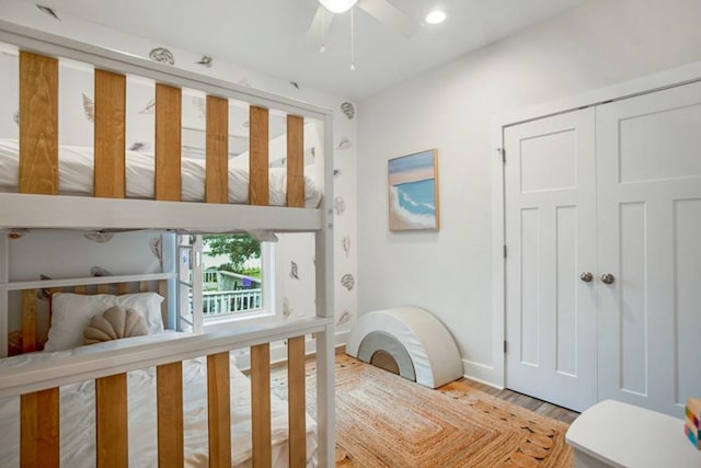 bedroom with ceiling fan and hardwood / wood-style flooring