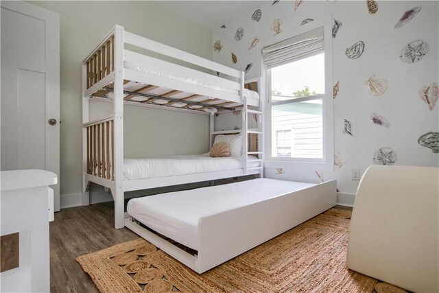 bedroom with crown molding, ceiling fan, and wood-type flooring