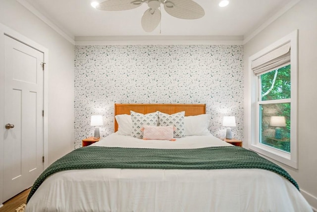 bedroom with hardwood / wood-style floors, ceiling fan, and crown molding