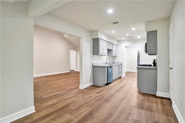 kitchen with gray cabinetry, appliances with stainless steel finishes, baseboards, light wood-type flooring, and recessed lighting