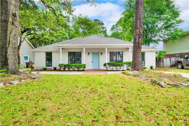 single story home with a front yard, a porch, and brick siding