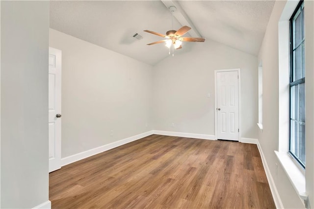 unfurnished room with a ceiling fan, wood finished floors, and baseboards