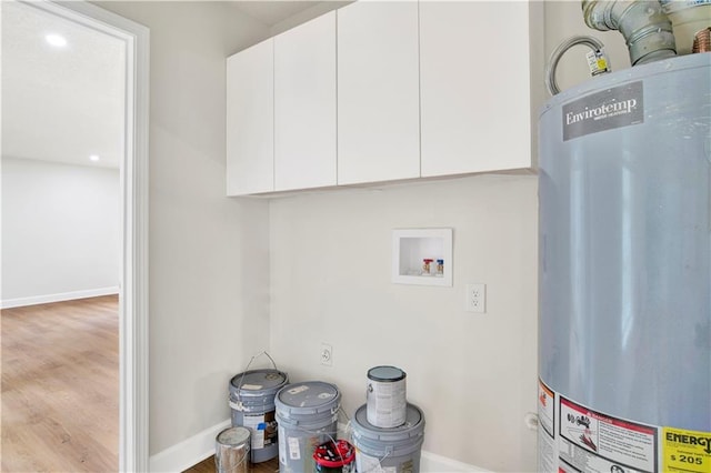 laundry area featuring gas water heater, washer hookup, wood finished floors, baseboards, and recessed lighting