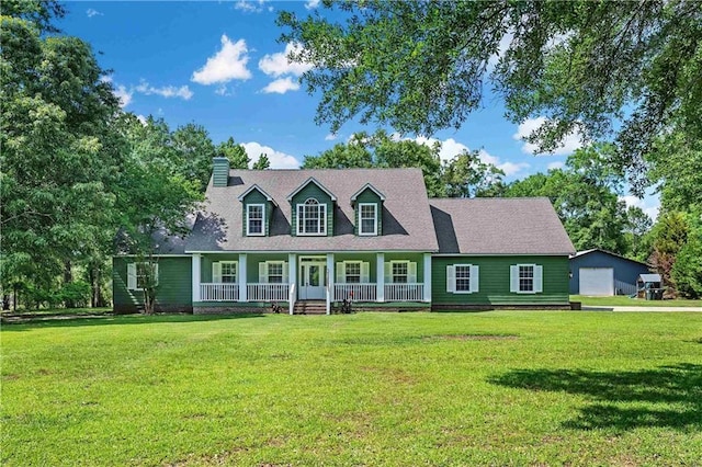 8255A Dixon Rd, Bay Minette, AL 36507 - new england style home with a porch, a chimney, a front lawn, and a garage