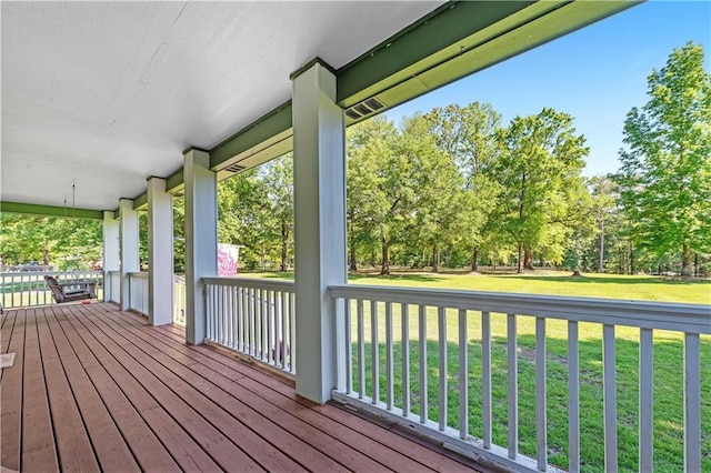 8255A Dixon Rd, Bay Minette, AL 36507 - wooden deck featuring a porch, a lawn, and view of wooded area