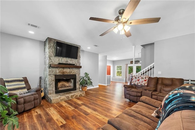 8255A Dixon Rd, Bay Minette, AL 36507 - living room featuring wood finished floors, ceiling fan, a stone fireplace, and baseboards