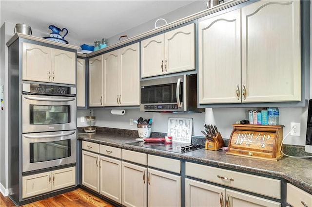 8255A Dixon Rd, Bay Minette, AL 36507 - kitchen featuring stainless steel appliances, dark countertops, and wood finished floors