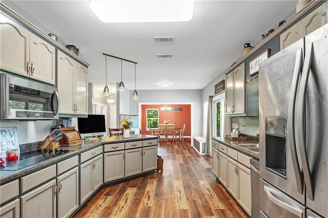 8255A Dixon Rd, Bay Minette, AL 36507 - kitchen with appliances with stainless steel finishes, dark countertops, a peninsula, and dark wood-type flooring