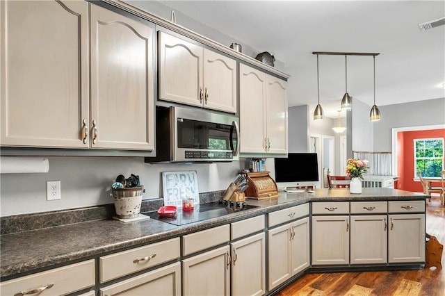 8255A Dixon Rd, Bay Minette, AL 36507 - kitchen with stainless steel microwave, black electric stovetop, dark wood finished floors, dark countertops, and a peninsula