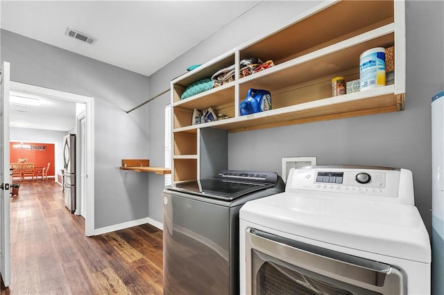 8255A Dixon Rd, Bay Minette, AL 36507 - laundry area with washing machine and dryer, dark wood finished floors, and baseboards