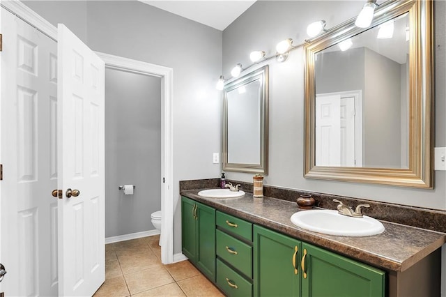 8255A Dixon Rd, Bay Minette, AL 36507 - full bathroom featuring toilet, double vanity, tile patterned floors, and baseboards