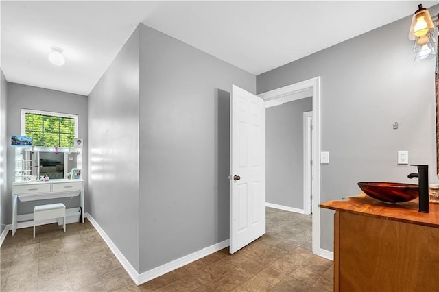 8255A Dixon Rd, Bay Minette, AL 36507 - corridor featuring a sink, baseboards, and stone finish flooring