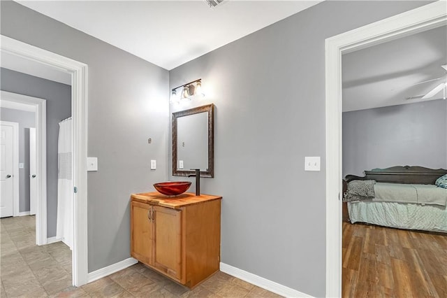 8255A Dixon Rd, Bay Minette, AL 36507 - bathroom featuring baseboards, a ceiling fan, and vanity