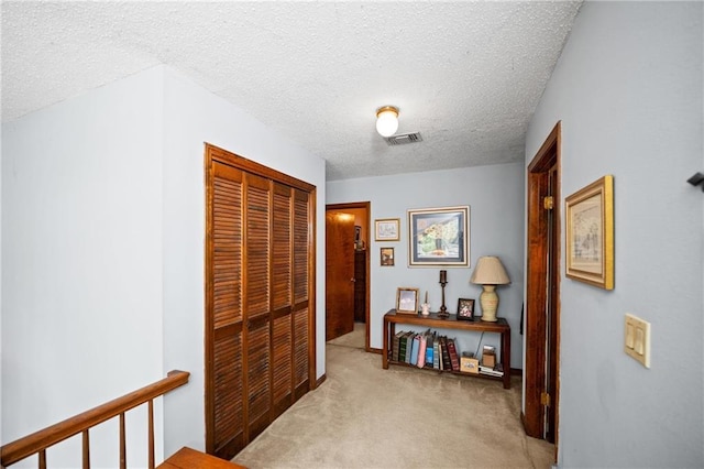 112 Broadmoor Dr, Daphne, AL 36526 - hallway with light colored carpet, a textured ceiling, and an upstairs landing