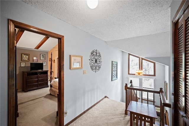 112 Broadmoor Dr, Daphne, AL 36526 - hall featuring an upstairs landing, carpet, vaulted ceiling, and a textured ceiling