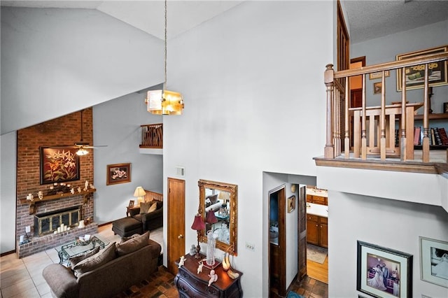 112 Broadmoor Dr, Daphne, AL 36526 - living area with high vaulted ceiling, a fireplace, a chandelier, and ceiling fan