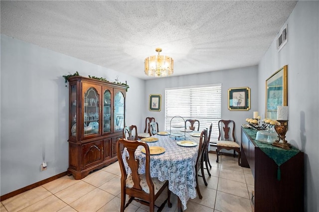 112 Broadmoor Dr, Daphne, AL 36526 - dining space featuring a chandelier, light tile patterned floors, and a textured ceiling