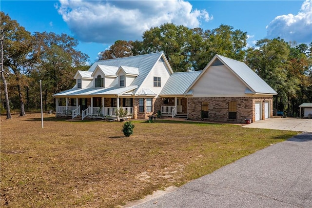 view of front of house featuring a front yard, a porch, and a garage