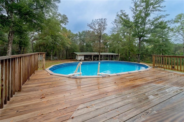 view of swimming pool with a wooden deck