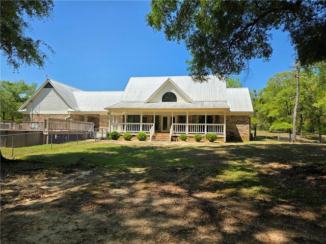9075 Hamm Cir, Wilmer, AL 36587 - back of house featuring stone siding, a porch, and metal roof