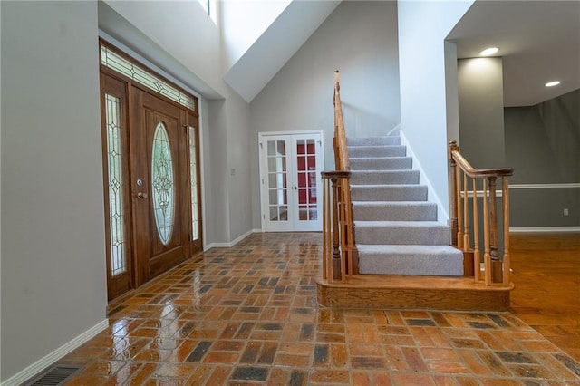 9075 Hamm Cir, Wilmer, AL 36587 - foyer entrance featuring french doors, baseboards, stairway, brick flooring, and recessed lighting