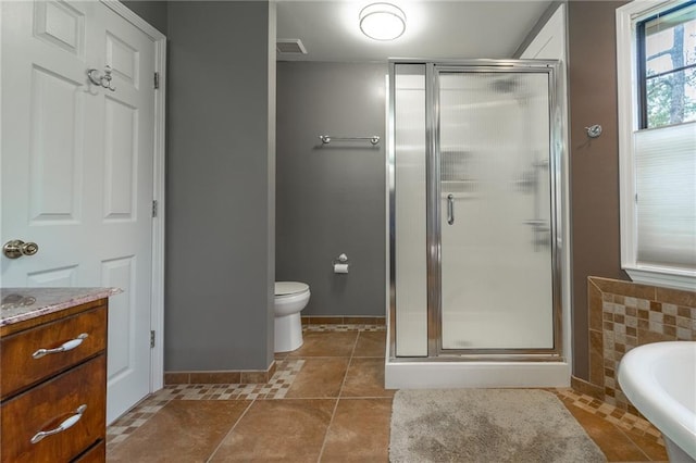 full bathroom featuring toilet, shower with separate bathtub, vanity, and tile patterned floors