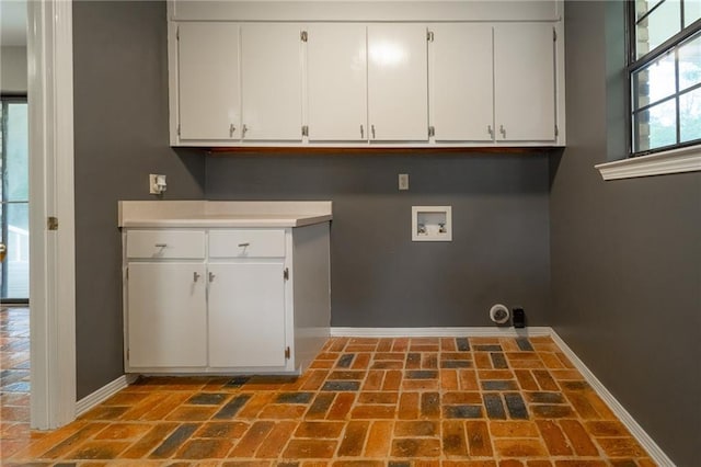 9075 Hamm Cir, Wilmer, AL 36587 - laundry room with baseboards, washer hookup, cabinet space, and brick flooring